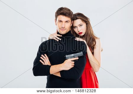 Portrait of beautiful stylish young couple with gun