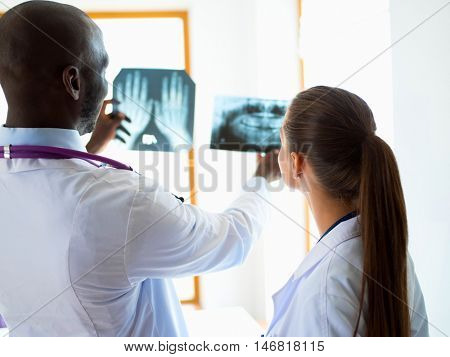 Doctors analyzing an x-ray in a meting