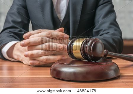 Justice And Law Concept. Lawyer Has Clasped Hands And Gavel In F