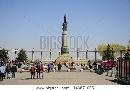 May 4 2016. Harbin China. Chinese tourists walking around the landmark Harbin flood control monument square in Harbin China located in Heilongjiang Province.