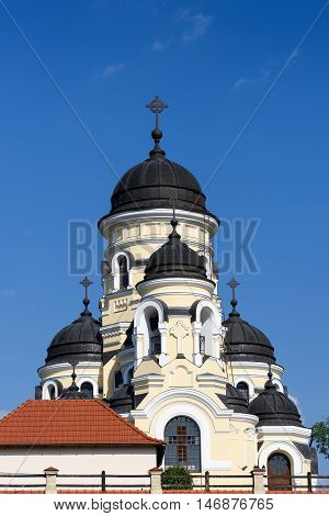 Photo of Capriana Monastery in Moldova with blue sky