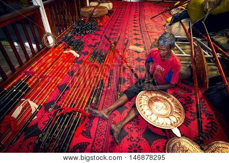 COLOMBO SRI LANKA - FEBRUARY 16 2016: Unidentified man preparing religious props for Perahera - one of the grandest and holiest events in Sri Lanka