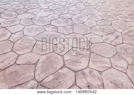 Closeup surface brick pattern at old red stone brick floor at pathway texture background