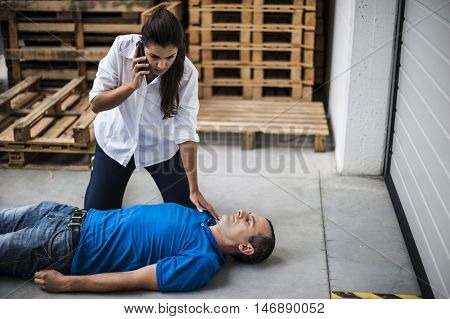 girl calling emergency service for an unconscious man