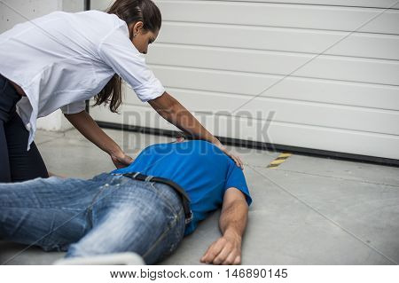 girl assisting an unconscious man after fatal accident