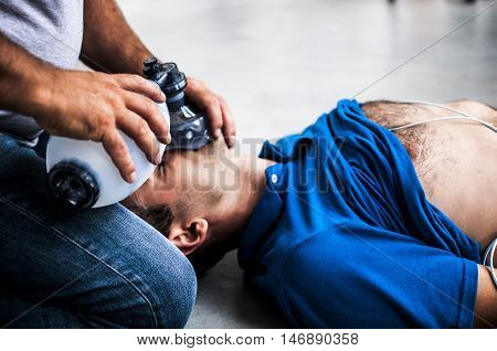 a man making CPR to an unconscious man