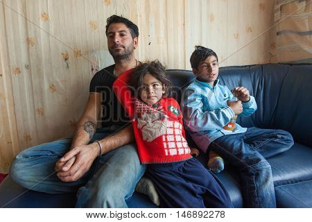ZAGREB, CROATIA - OCTOBER 21, 2013: Roma man and his children at their home.