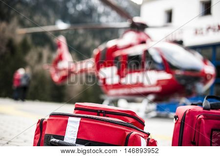emergency bags and rucksacks near a rescue helicopter