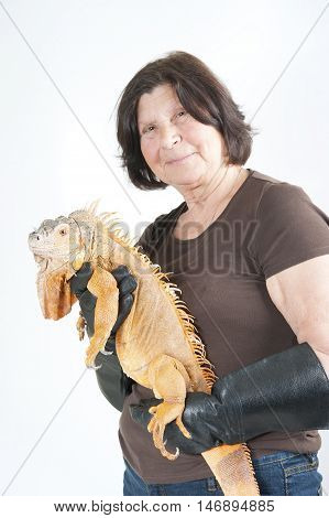 Elderly Woman With Iguana On His Hands..