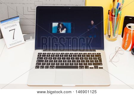 PARIS FRANCE - SEP 8 2016: Apple Computers website on MacBook Retina in room environment showcasing live coverage of Apple Keynote - presentation of iPhone new photo camera double camera