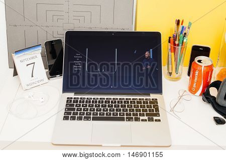 PARIS FRANCE - SEP 8 2016: Apple Computers website on MacBook Retina in room environment showcasing live coverage of Apple Keynote - presentation of iPhone new photo camera double camera