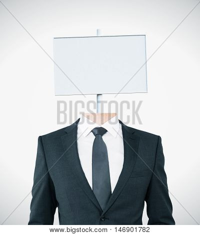 Young businessman body with white signboard instead of head on light background. Mock up