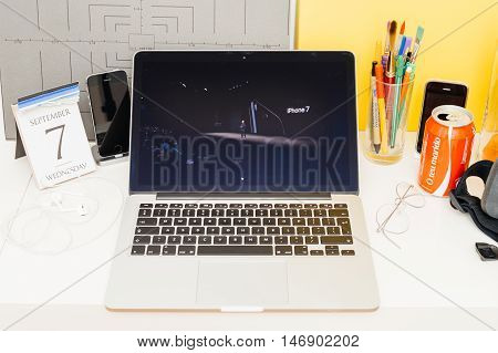 PARIS FRANCE - SEP 8 2016: Apple Computers website on MacBook Retina in room environment showcasing live coverage of Apple Keynote - Tim Cook presenting the new iPhone 7