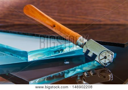glass and glass cutter closeup on wooden background