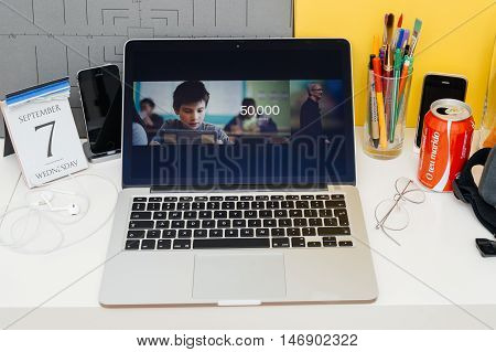 PARIS FRANCE - SEP 8 2016: Apple Computers website on MacBook Retina in room environment showcasing live coverage of Apple Keynote - Timm Coock about donation of 50000 iPAds