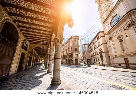 Turin, Italy - June 12, 2016: Street view with arch gallery and beautiful buildings in the center of Turin old town in Piedmont region in Italy