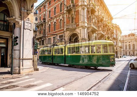 Turin, Italy - June 12, 2016: Street view with old green tram in the old city center of Turin in the morning in Piedmont region in Italy