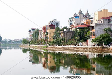 Ladnscape Of Hanoi With Buildings Reflected In The River