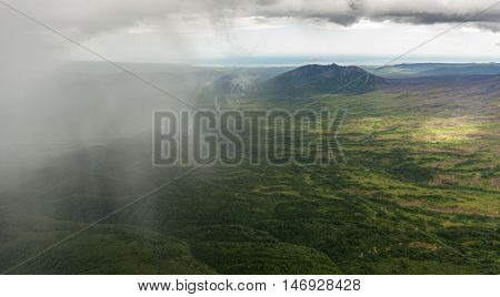 Rain in the Kronotsky Nature Reserve on Kamchatka Peninsula. View from helicopter.