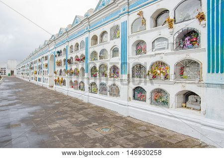 TULCAN, ECUADOR - JULY 3, 2016: one of the paths in the cementery with lot of graves located on the right side.