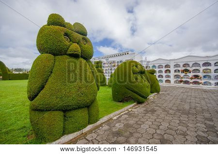 TULCAN, ECUADOR - JULY 3, 2016: animal sculptures located at the side of one path of the cemetery.