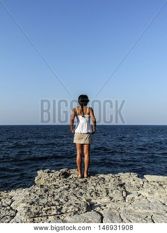 girl admiring the deep blue sea by the riff
