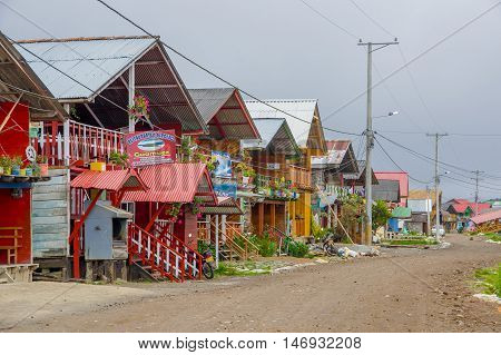 PASTO, COLOMBIA - JULY 3, 2016: some nice and colorfull wood houses with tin roof on the shore of lago la cocha.