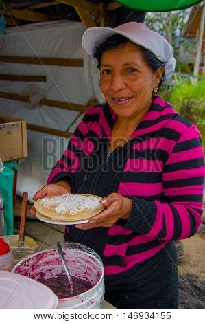 PASTO, COLOMBIA - JULY 3, 2016: unidentified woman from a location close to la cocha preparing a dessert.