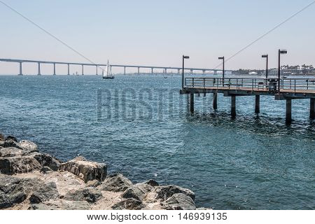 Fishing pier at Embarcadero Park South in San Diego, California, with the Coronado Bridge in the background.