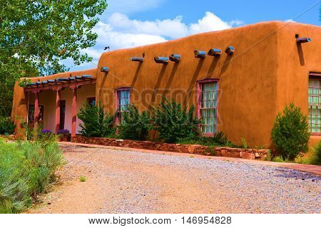 Historic style adobe building surrounded by a garden taken in Santa Fe, NM