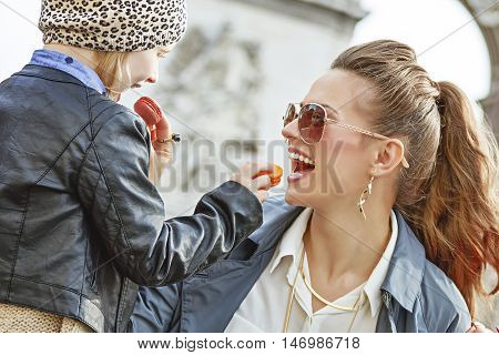 Mother And Daughter Near Arc De Triomphe Eating Macaroons