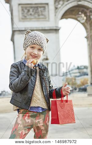 Girl Near Arc De Triomphe In Paris Holding French Macaroon
