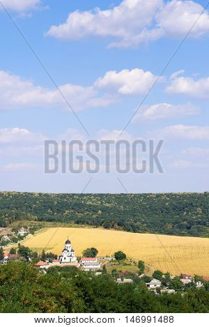 Landscape view with Capriana Monastery and the village in Moldova surrounded by forest