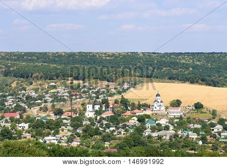 Landscape view with Capriana Monastery and the village in Moldova surrounded by forest