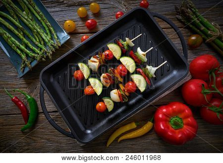 brochette vegetable on grill pan with tomato onion pepper zucchini
