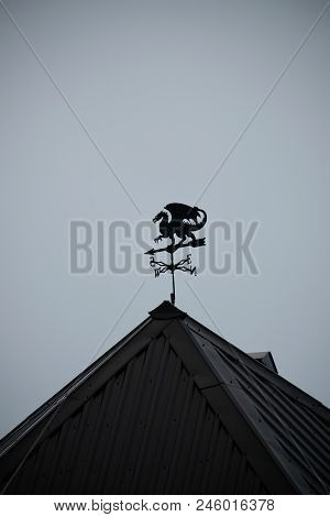Black Dragon Wind Vane Against The Sky.