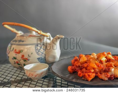On Seletive Focus And Dark Image Of Fried Chicken Sauce Cook A Special Dish In Black. And The Teacup