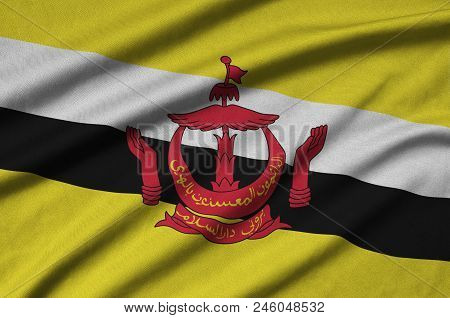 Brunei Darussalam Flag  Is Depicted On A Sports Cloth Fabric With Many Folds. Sport Team Waving Bann