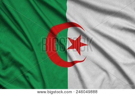 Algeria Flag  Is Depicted On A Sports Cloth Fabric With Many Folds. Sport Team Waving Banner