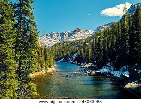Lake Verna with rocks and mountains around at autumn. Rocky Mountain National Park in Colorado, USA. 