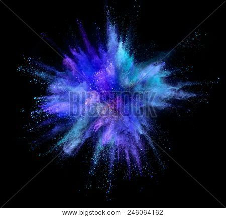 Explosion of coloured powder isolated on black background. Freeze motion of abstract colors shape in sphere shape
