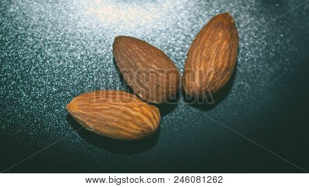 Raw Almonds Nuts On The Wooden Background