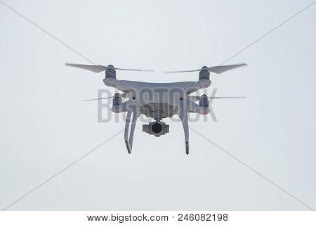White Quadrupter With Propellers Flies In The Sky And Photographs Landscapes