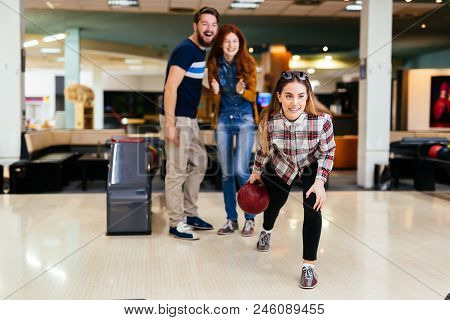 Friends Having Fun While Bowling And Speding Time Together