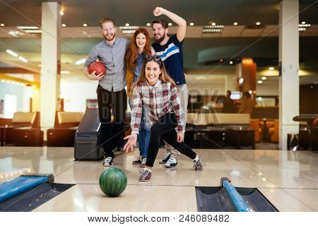 Friends Having Fun While Bowling And Speding Time Together