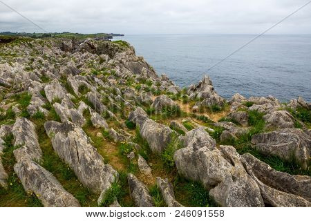 Coastal cliffs near of the beach Gulpiyuri, Asturias, Spain
