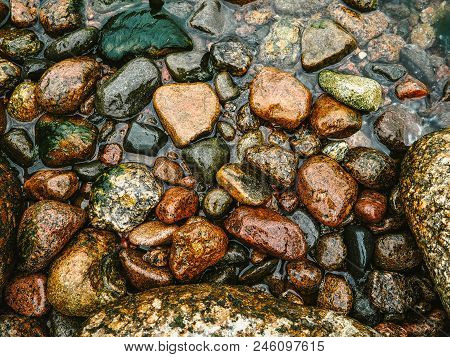 Wet Sea Stones In The Water. Top View. Water