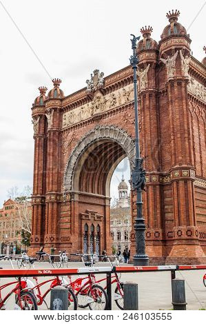 Barcelona - March, 2018: Public Bike System Bicycles Nex To The Triumphal Arch In Barcelona Spain