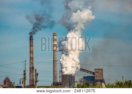 Smoke From Pipes In The Plant, Polluting The Environment. Dirty Air In The Sky.