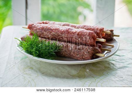 Raw Lulya Kebab From Meat On A White Plate.